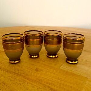 Stunning four glass gold and smokey amber shot glasses.